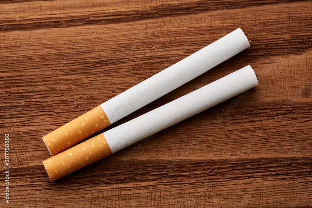 cigarettes close-up on a wooden background. Drug addiction. Smoking of tobacco. cancer. Nicotine. Bad habit. cigarettes close-up on a wooden background. Drug addiction. Smoking of tobacco. cancer. Nicotine. Bad habit.