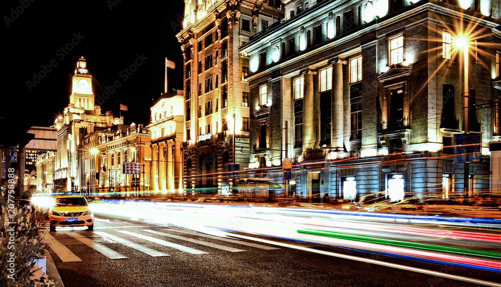  colorful lights and long exposure stripes of moving cars on the streets of shanghai pudong skyline, China