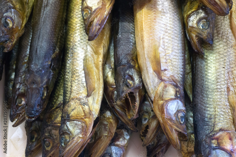 Obraz premium Capelin smoked on brown wooden table. Soft focus.