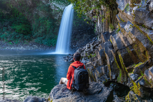 Man watching the Bassin La Paix waterfall in Reunion Island