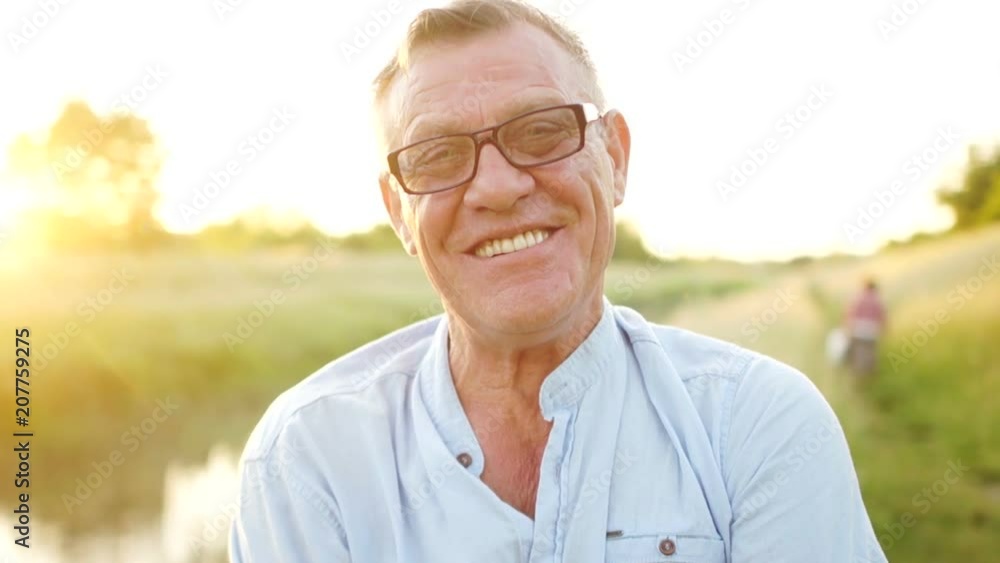 Retiree Smiling Close-up portrait of a smiling, cheerful retiree. A man in optical ...