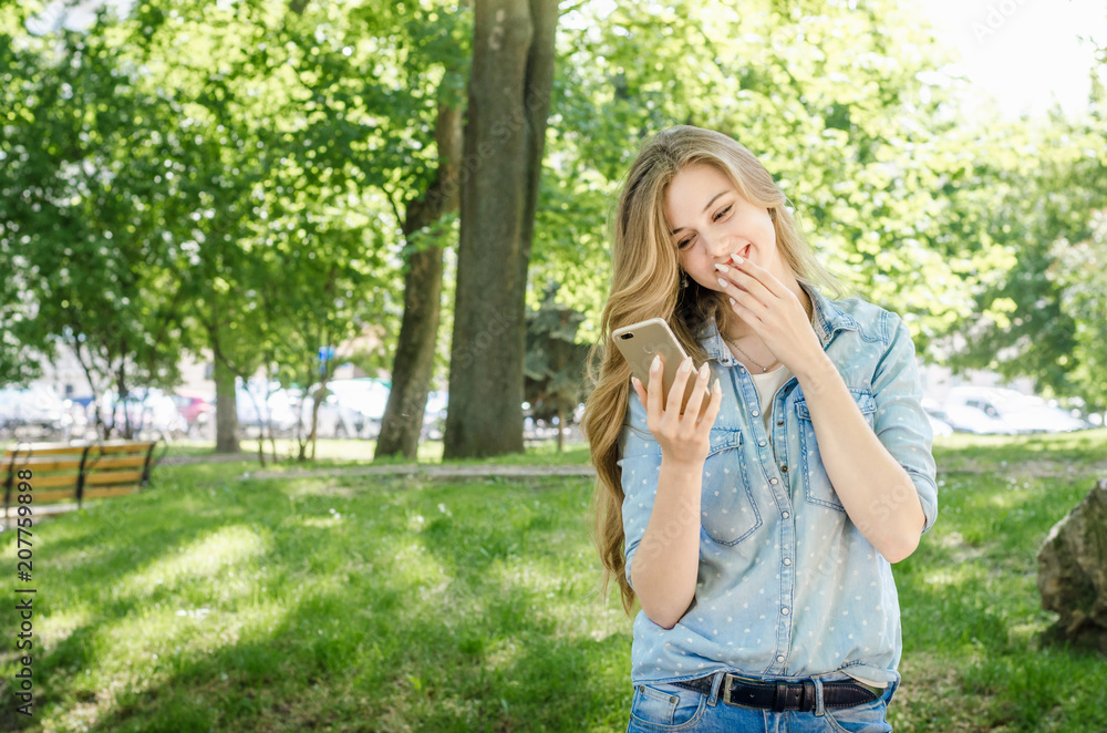 Smiling bussines casual woman holding call smartphone mobile cell with long hair in green nature park sunny day background Smiling bussines casual woman holding call smartphone mobile cell with long hair in green nature park sunny day background