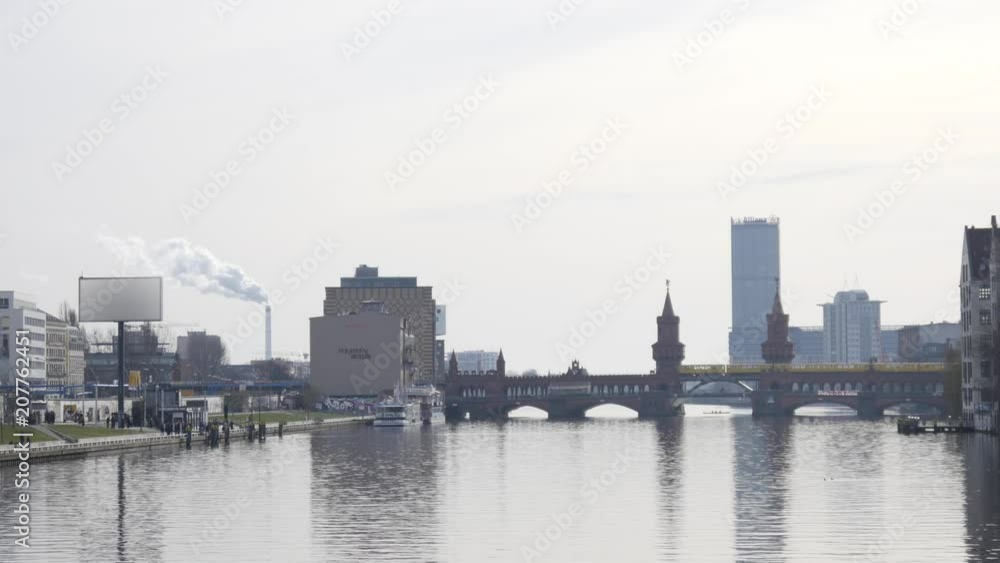 Early morning in Berlin, U-Bahn Crosses the Oberbaum Bridge, building silhouettes Early morning in Berlin, U-Bahn Crosses the Oberbaum Bridge, building silhouettes