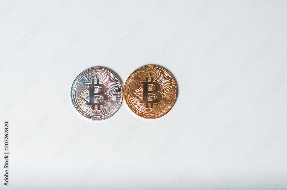 Silver and gold bitcoin coin on a white background. The concept of crypto currency Silver and gold bitcoin coin on a white background. The concept of crypto currency