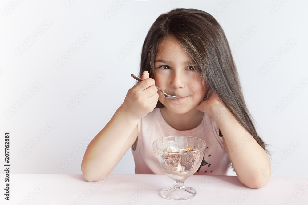 Happy child girl eating ice cream in white and chocolate bowl on white background. Enjoying delicious. Happy child girl eating ice cream in white and chocolate bowl on white background. Enjoying delicious.