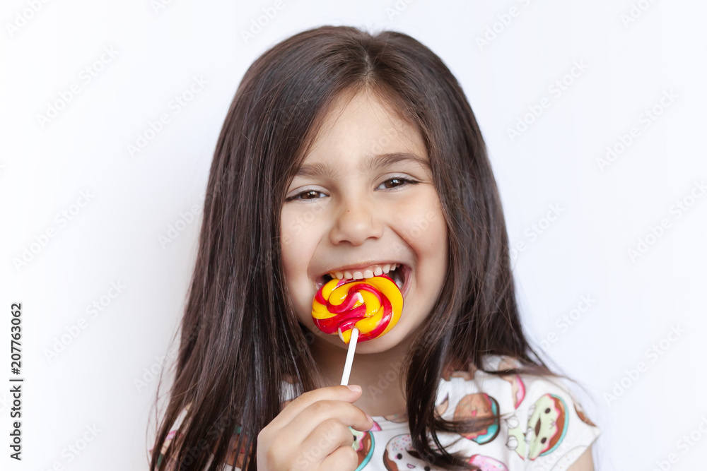 Beautiful cute little girl eating lollipop Beautiful cute little girl eating lollipop