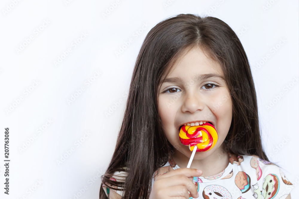 Beautiful cute little girl eating lollipop Beautiful cute little girl eating lollipop