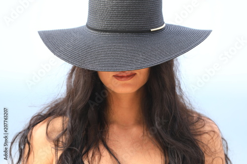 portrait of sensual sexy girl in black hat and in bikini at sea