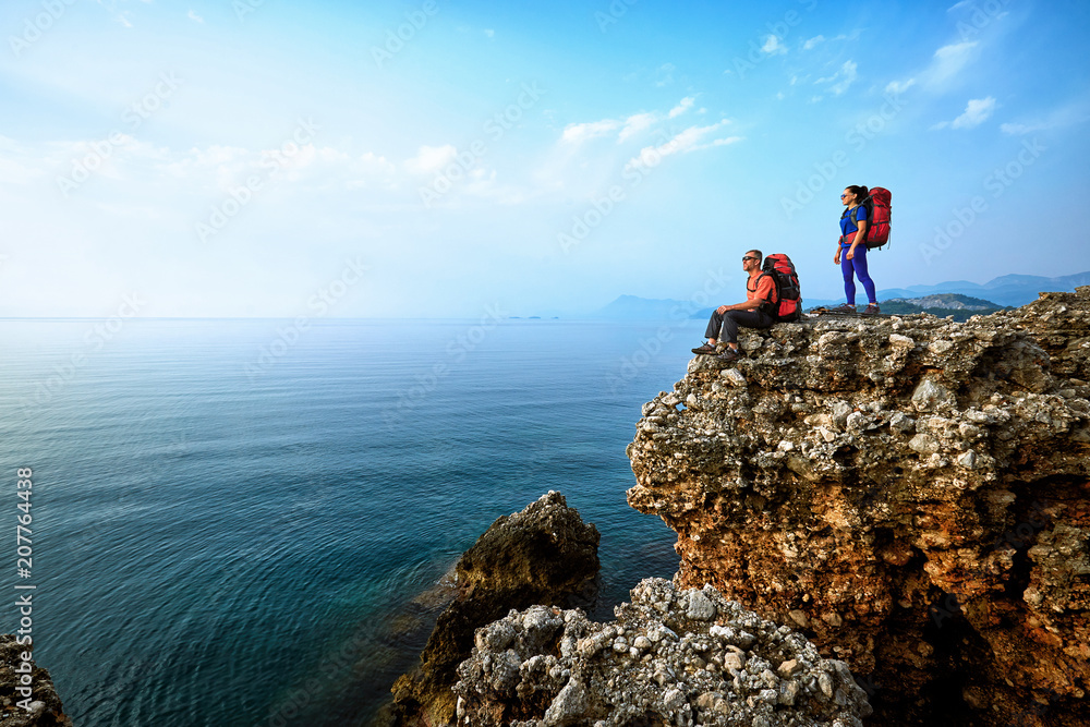 Adventure trek along the coast with a backpack in the summer.