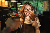 Portrait of a happy young barista girl in apron