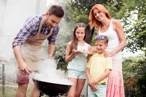 Young family make barbecue at their home