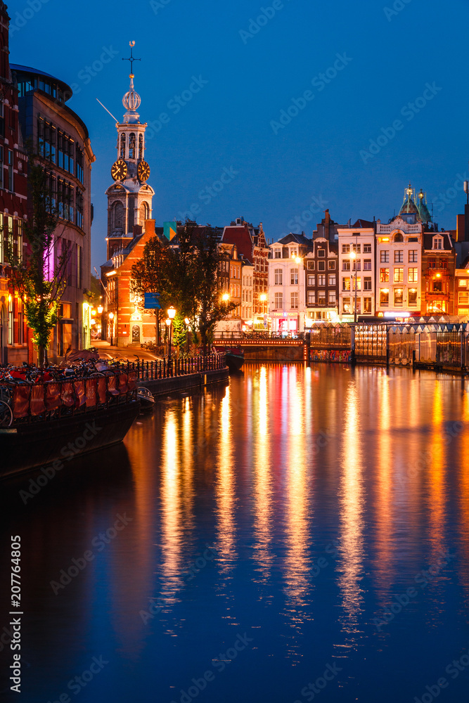 Evening building on the streets and amsterdam channels with illumination