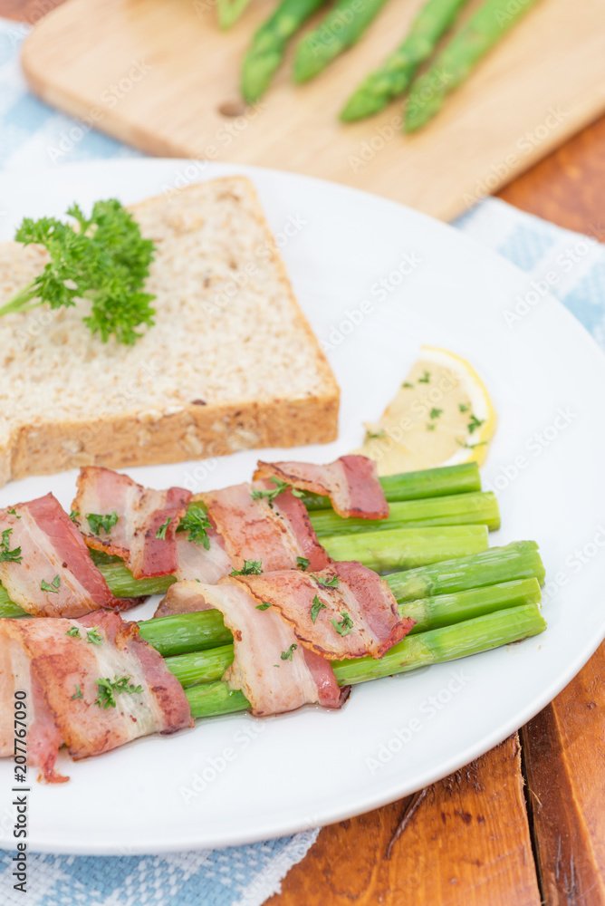 Fresh Young Asparagus Wrapped in Prosciutto Meat and Grilled on pan
Fresh Young Asparagus Wrapped in Prosciutto Meat and Grilled on pan