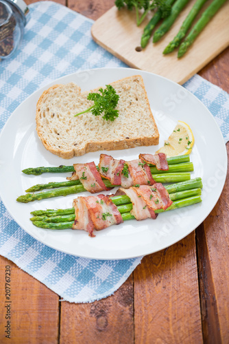 Fresh Young Asparagus Wrapped in Prosciutto Meat and Grilled on pan


