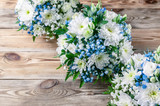 Wedding bouquets bridesmaids in white and blue chrysanthemums on a wooden background. Top view
