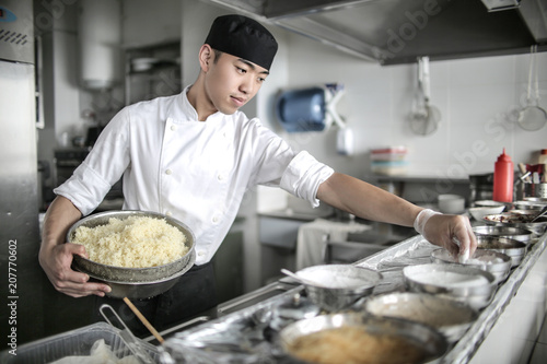 Chinese chef cooking in a restaurant kitchen