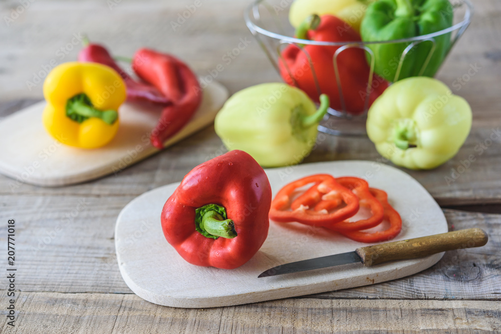 Selection of colorful peppers on wooden table. Cooking fresh food background. Selection of colorful peppers on wooden table. Cooking fresh food background.