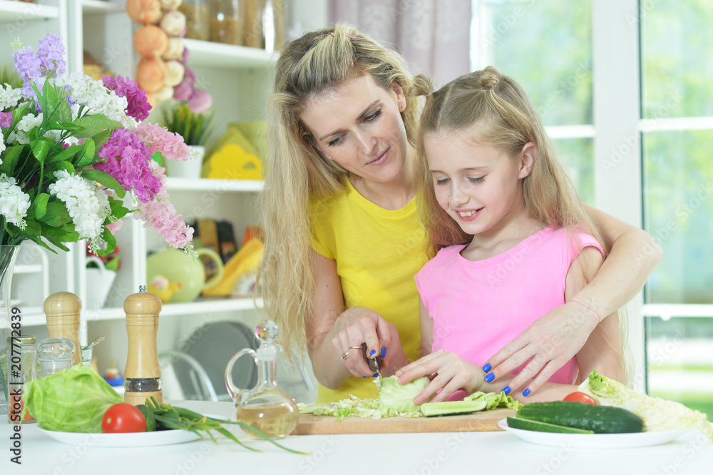 mother and daughter cooking together
