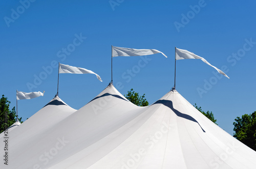 Four Pennants Waving in Air on White Tent