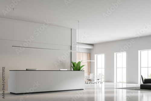 White reception desk with two computers side view