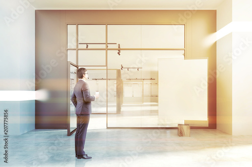 White wall poster gallery  glass door  businessman