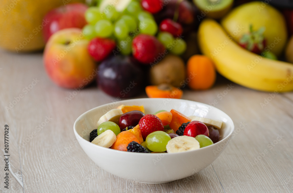 Healthy fresh fruit salad in white plate. Top view. Healthy fresh fruit salad in white plate. Top view.