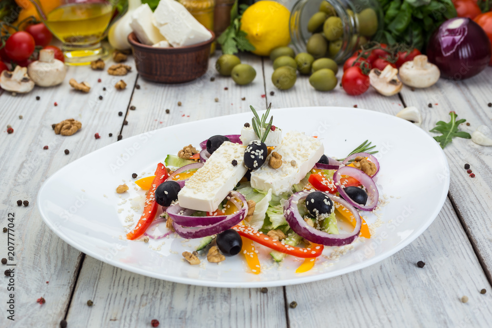 Greek salad with fresh vegetables, feta cheese and black olives Greek salad with fresh vegetables, feta cheese and black olives