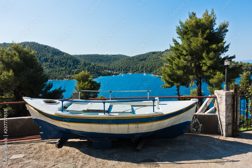 Boat at the viewpoint to Panormos bay, island of Skopelos, Greece