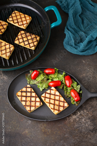 Tofu Grilled in a Cast Iron Grill Pan Served on a Cast Iron Plate with Salad