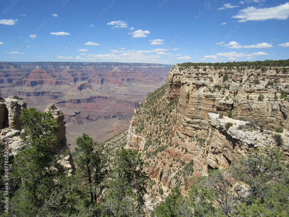 Grand Canyon views as seen from the South Rim Trail on a sunny day with blue sky and some clouds 