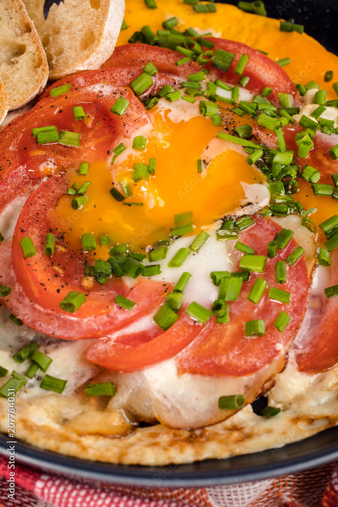 Homemade breakfast fried egg with tomato.
