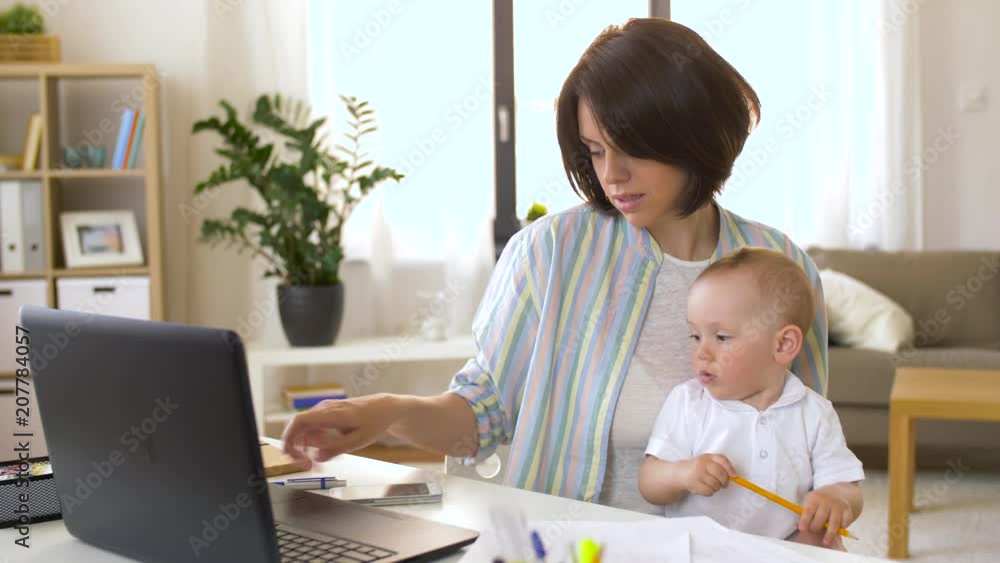 multi-tasking, freelance and motherhood concept - working mother with baby boy at home office calling on smartphone multi-tasking, freelance and motherhood concept - working mother with baby boy at home office calling on smartphone