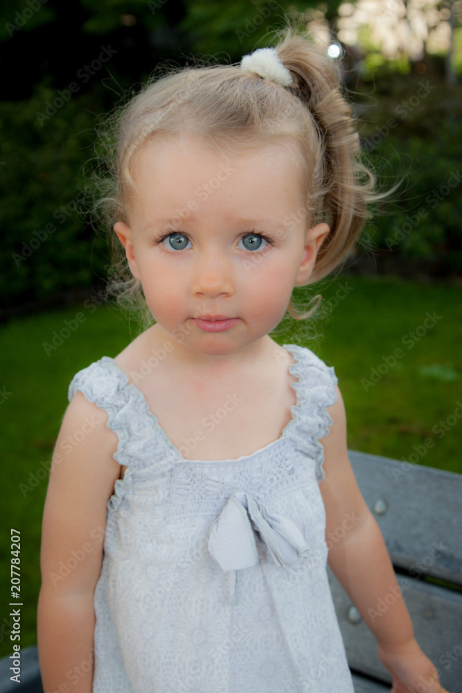 Portrait of sweet little girl play outdoors