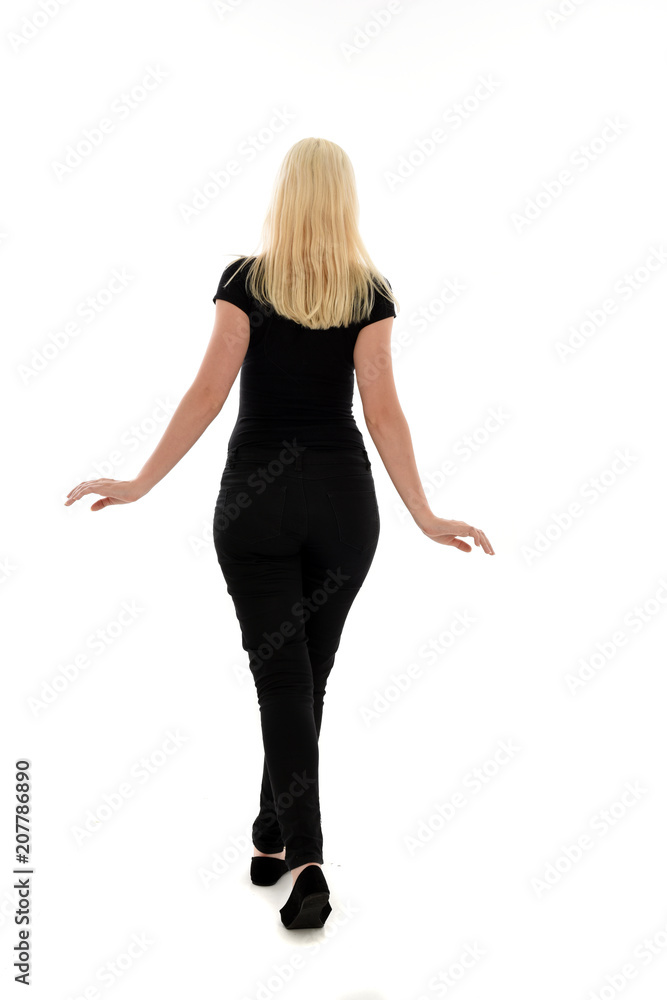 full length portrait of blonde girl wearing black clothing, isolated on white background.