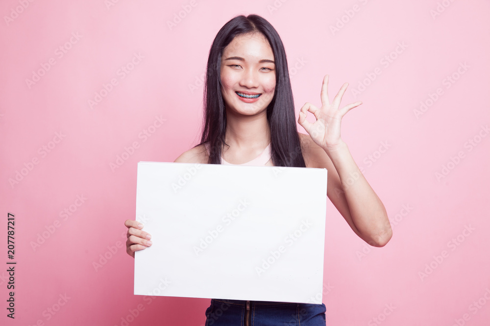 Young Asian woman show OK with white blank sign. Young Asian woman show OK with white blank sign.