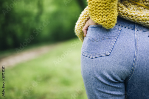 Woman buttocks in blue jeans