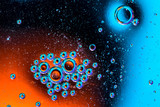 Macro shot of oil bubbles with water on colorful background. Space and universe planets styled abstract image
