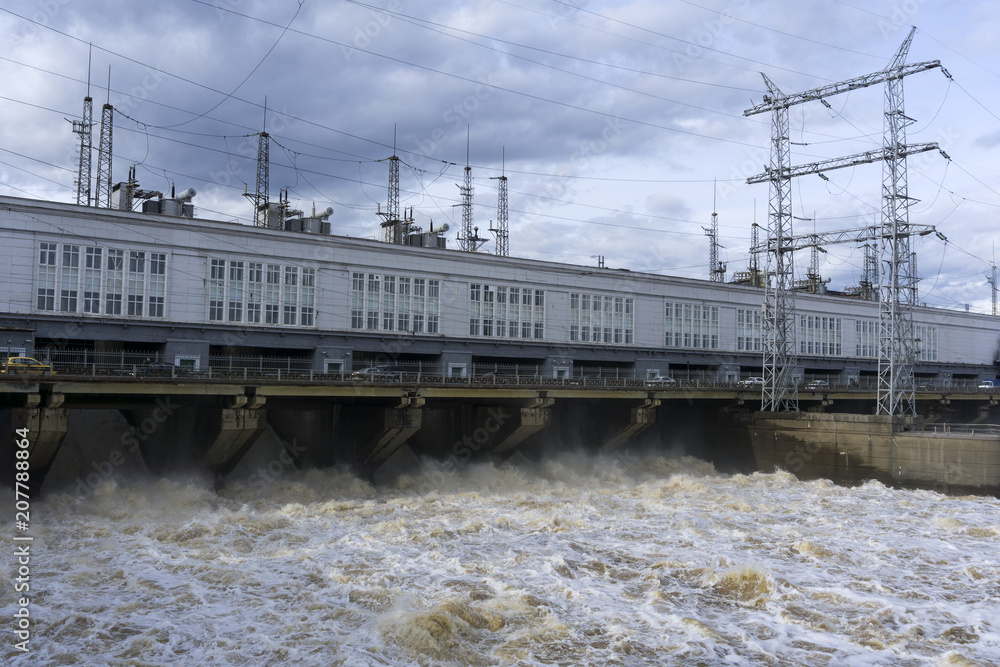dam hydroelectric power station on the river during the discharge of flood waters dam hydroelectric power station on the river during the discharge of flood waters