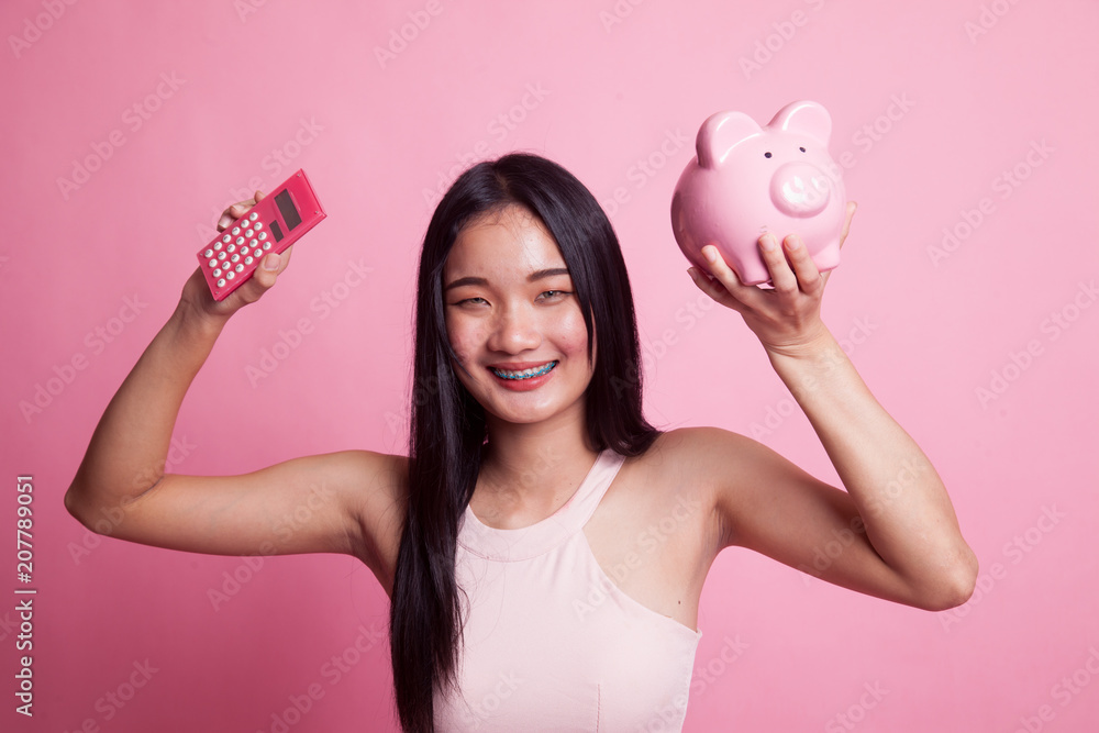 Asian woman with calculator and piggy bank. Asian woman with calculator and piggy bank.