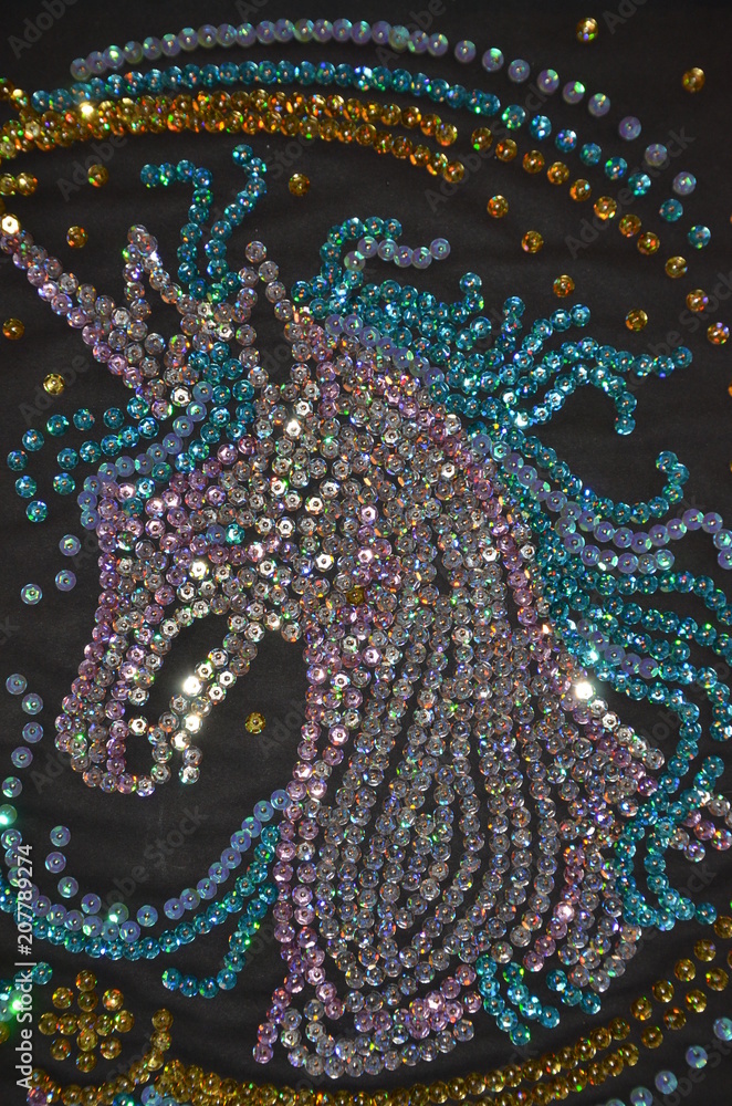 decorative horse pattern of sequins on black background