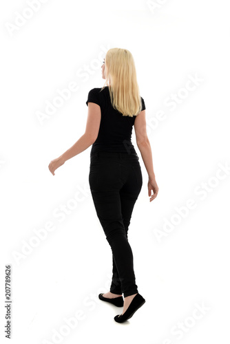 full length portrait of blonde girl wearing black clothing, isolated on white background.