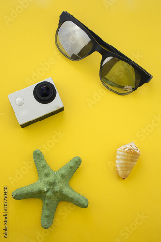 Summer holydays stuff concept. Seastar action camera sunglases shell