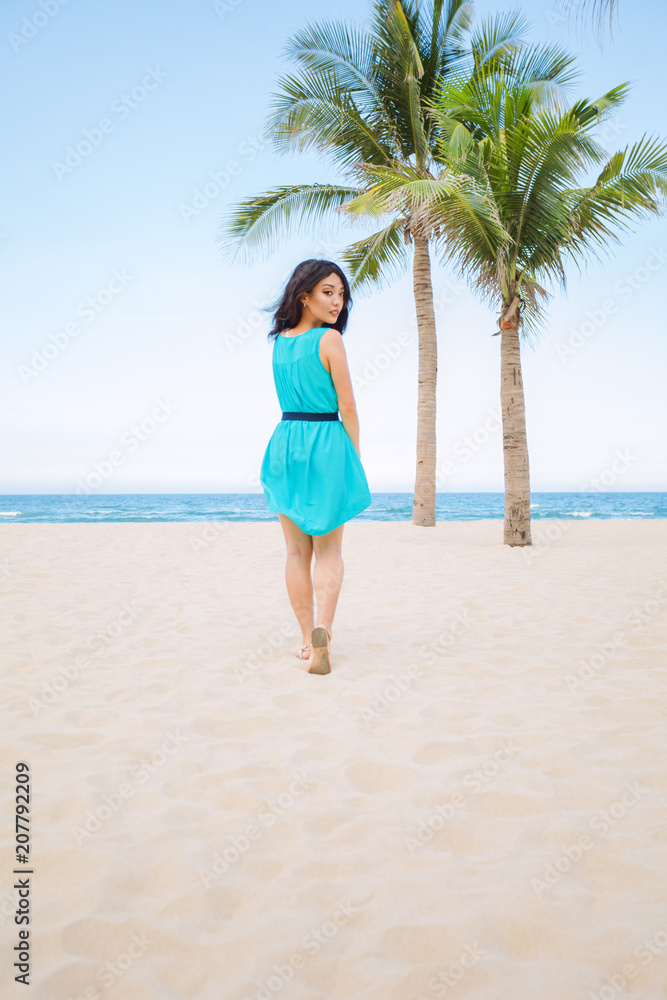 Young beautiful asian woman is walking on the beach Young beautiful asian woman is walking on the beach