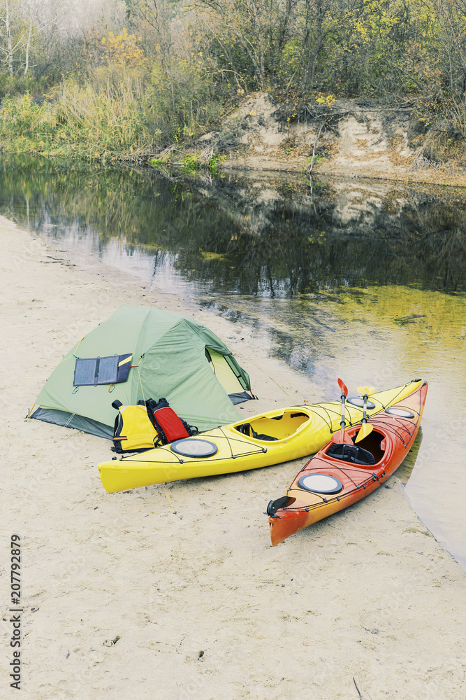 Kayaking on the Lake Concept Photo. Sport Kayak on the Rocky Lake Shore. Close Up Photo. Kayaking on the Lake Concept Photo. Sport Kayak on the Rocky Lake Shore. Close Up Photo.