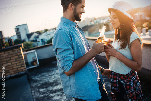 Happy couple enjoying drinks and balcony photo