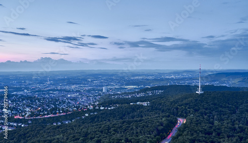 Night falls over Stuttgart City in Germany / Turning on the lights in the city