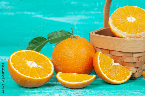 orange fruit on color table background.