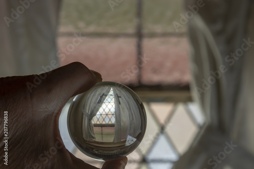 Stained glass window with curtains in crystal ball