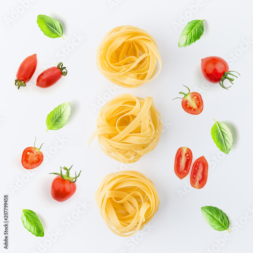 Fototapeta Naklejka Na Ścianę i Meble -  Pasta and ingredients on white background from top view. Italian food concept.