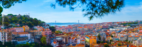 Summertime sunshine day cityscape panoramic view of town, Sao Jorge Castle, and all historic old centre in Lisbon, Portugal.